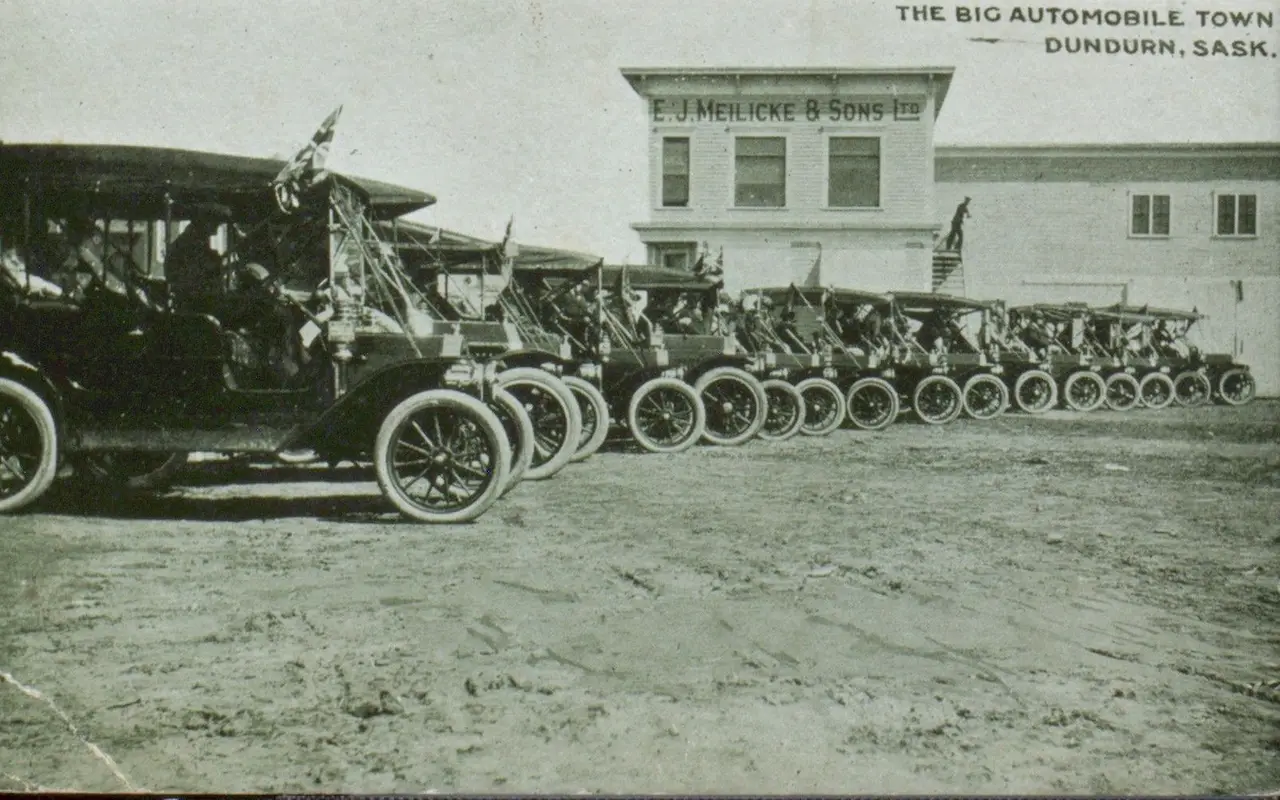 Row of early automobiles outside E.J. Meilicke & Sons Ltd., Dundurn, about 1912